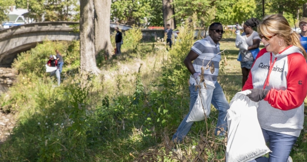 Employees work on a riverbank restoration project.