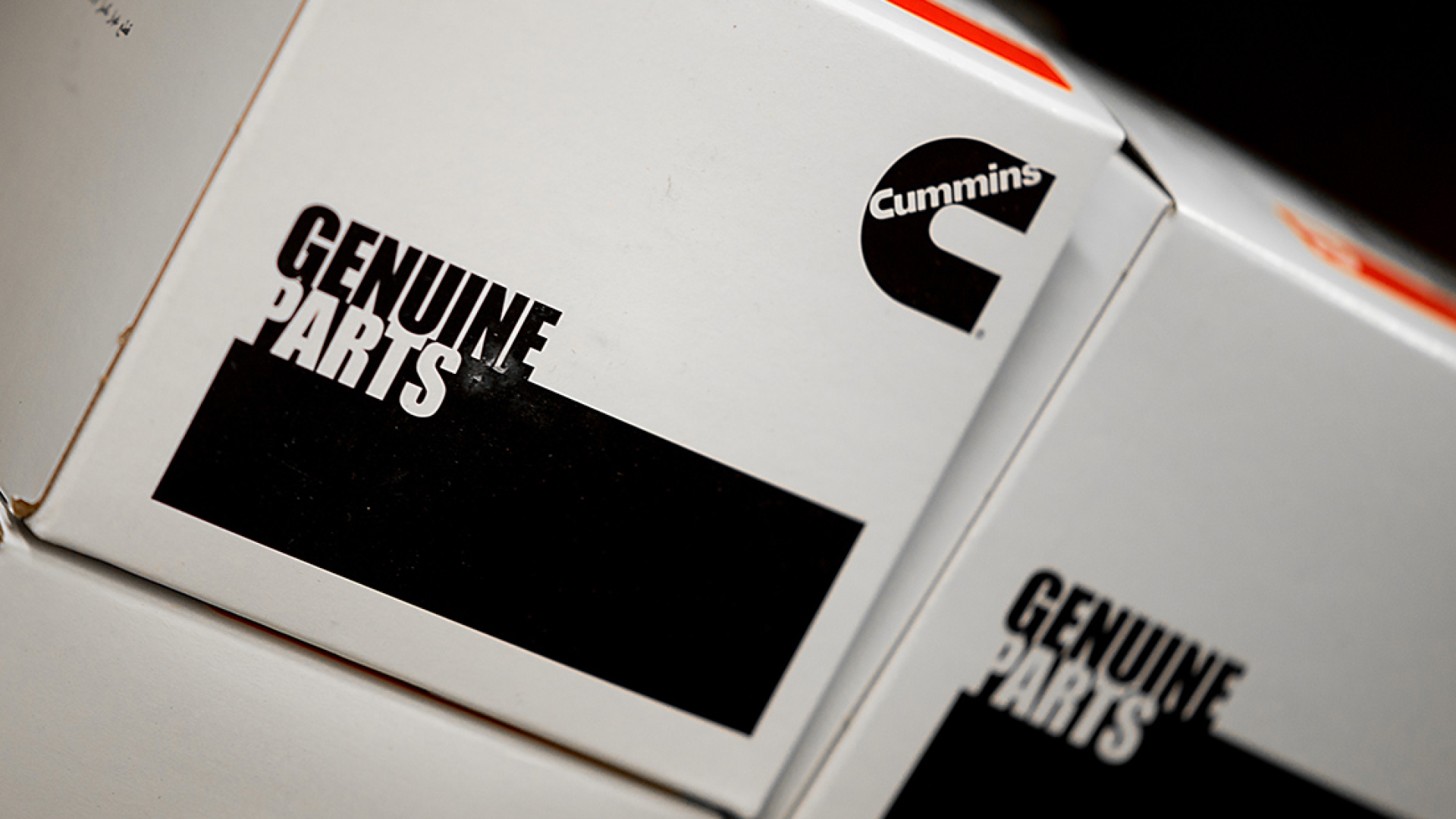 stack of Genuine Parts boxes
