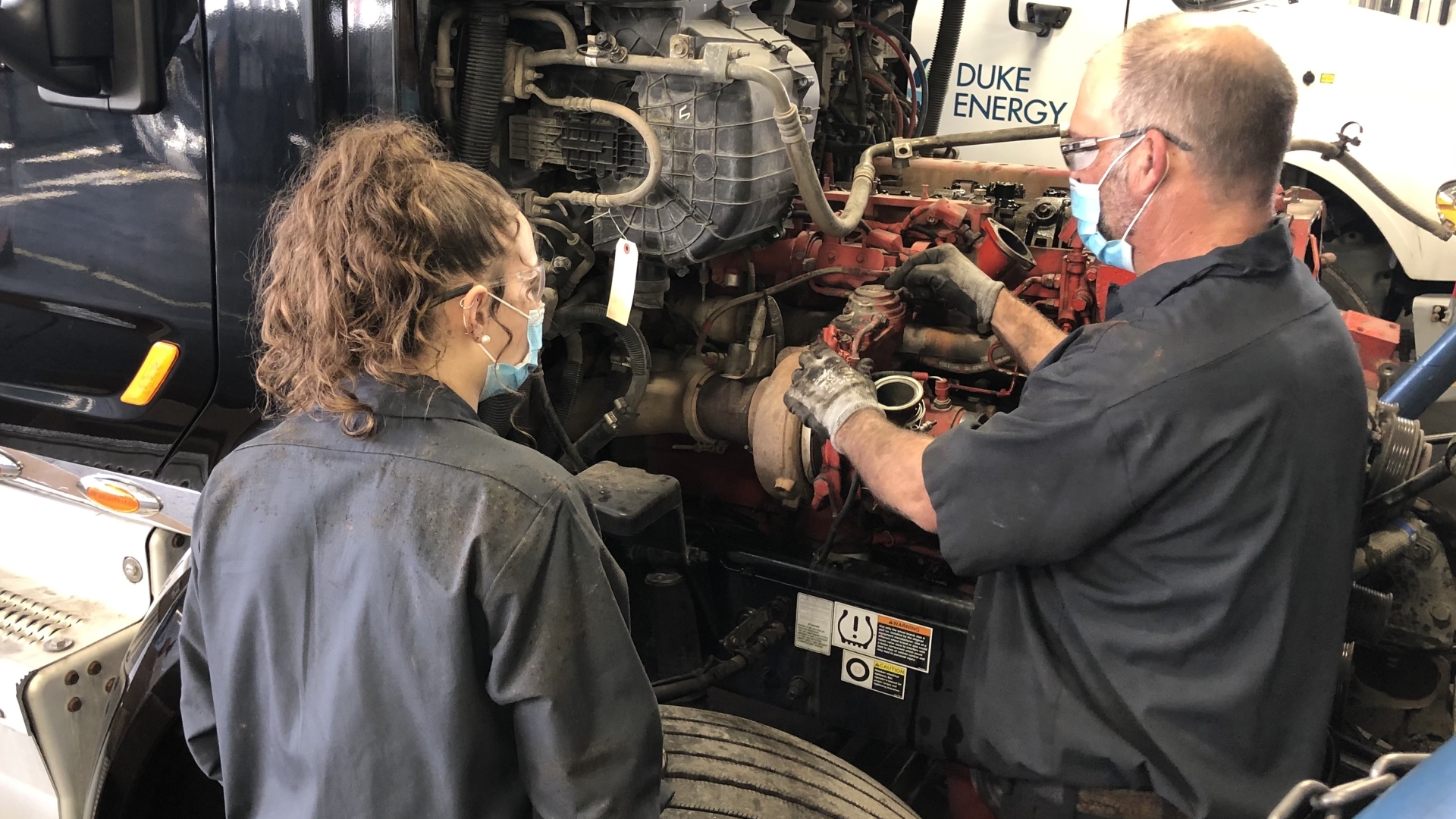 Annika "Niki" Rasband gets instruction from a Cummins technician