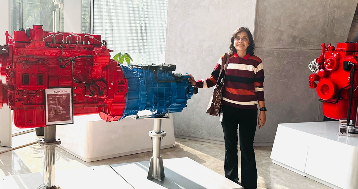 Employee standing next to engine prototypes