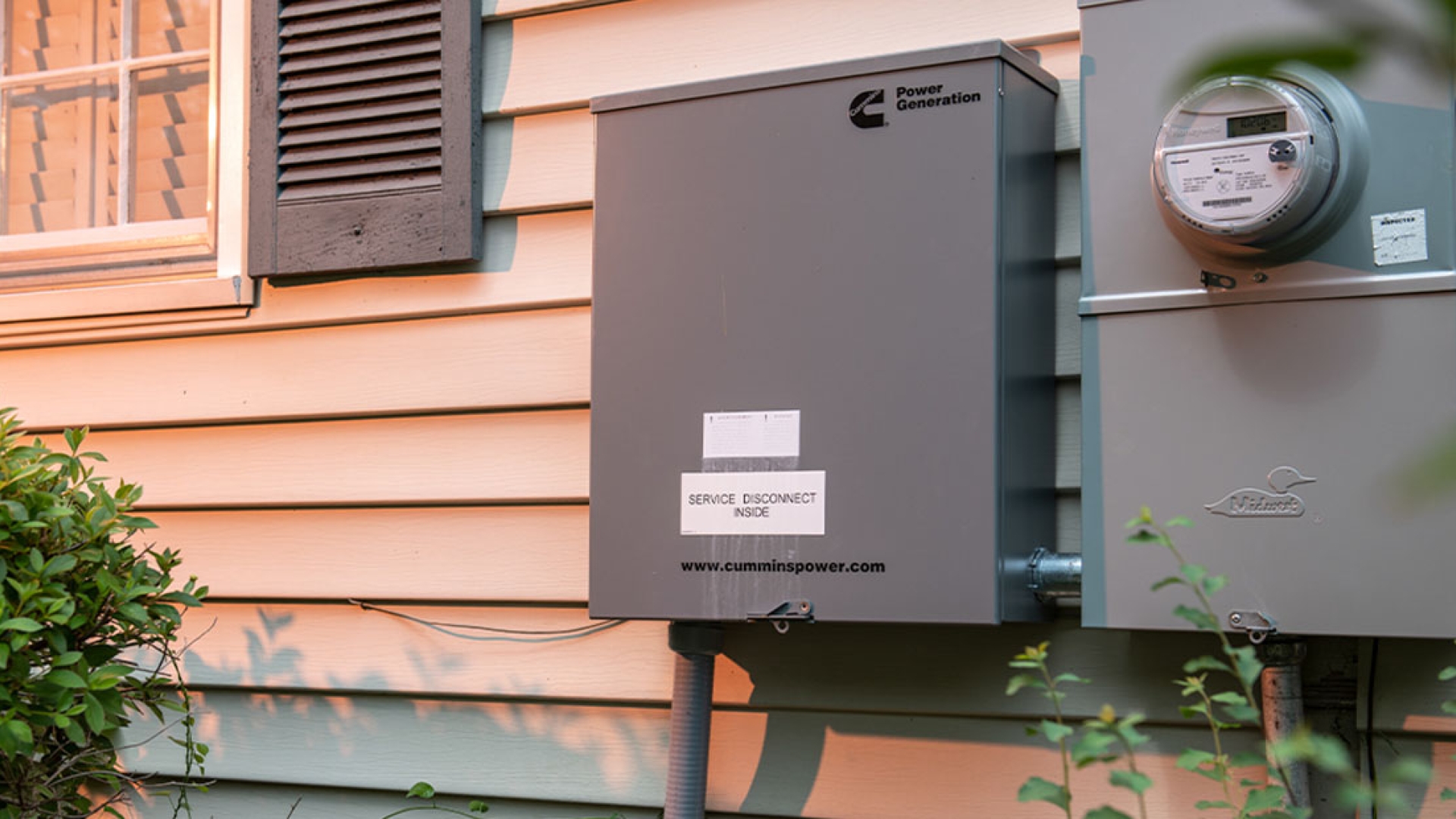 Cummins service disconnect box mounted on side of house