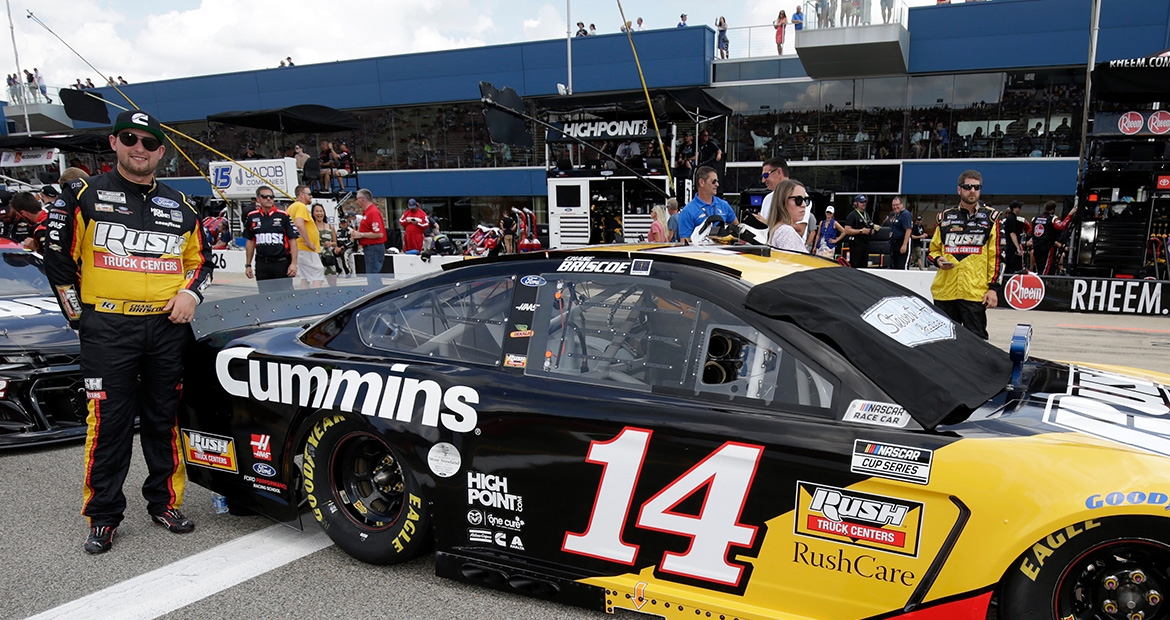 Chase Briscoe posing next to #14 car