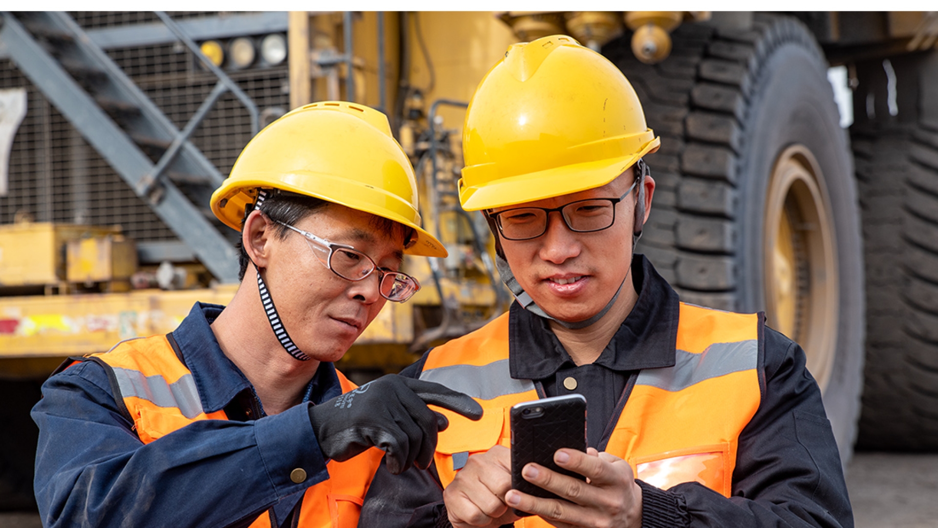 Two employees looking at phone