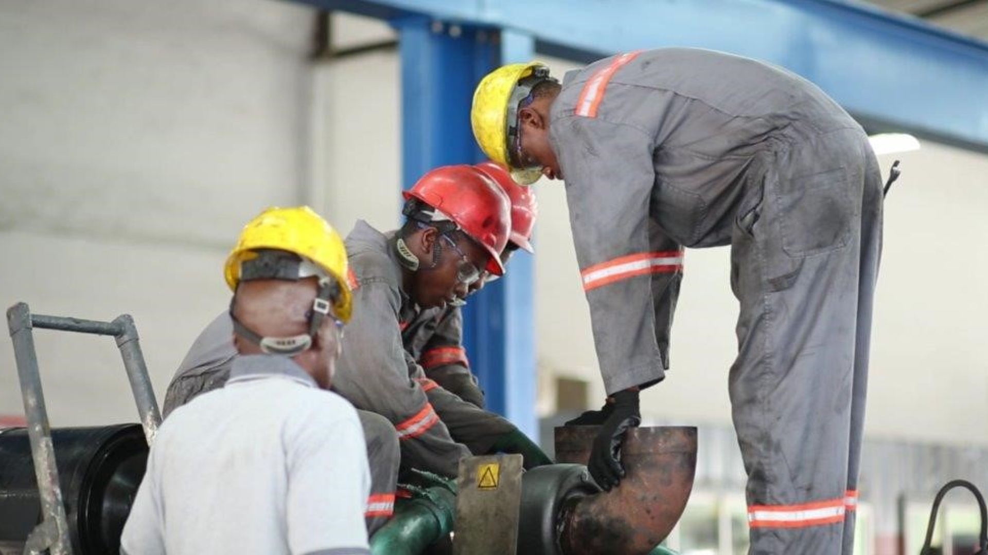 Workers inspecting a pipe