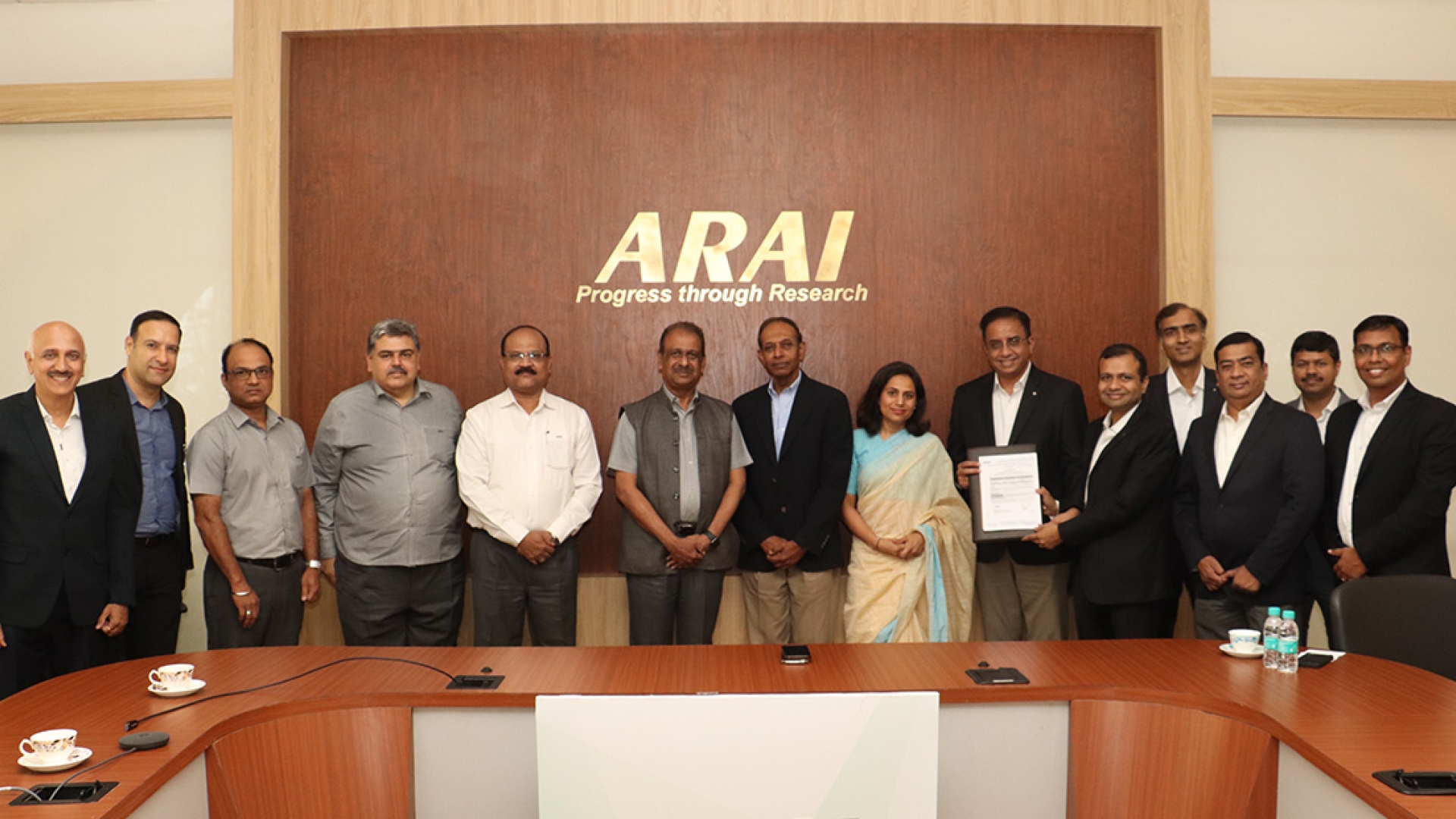 group of people holding signed contract