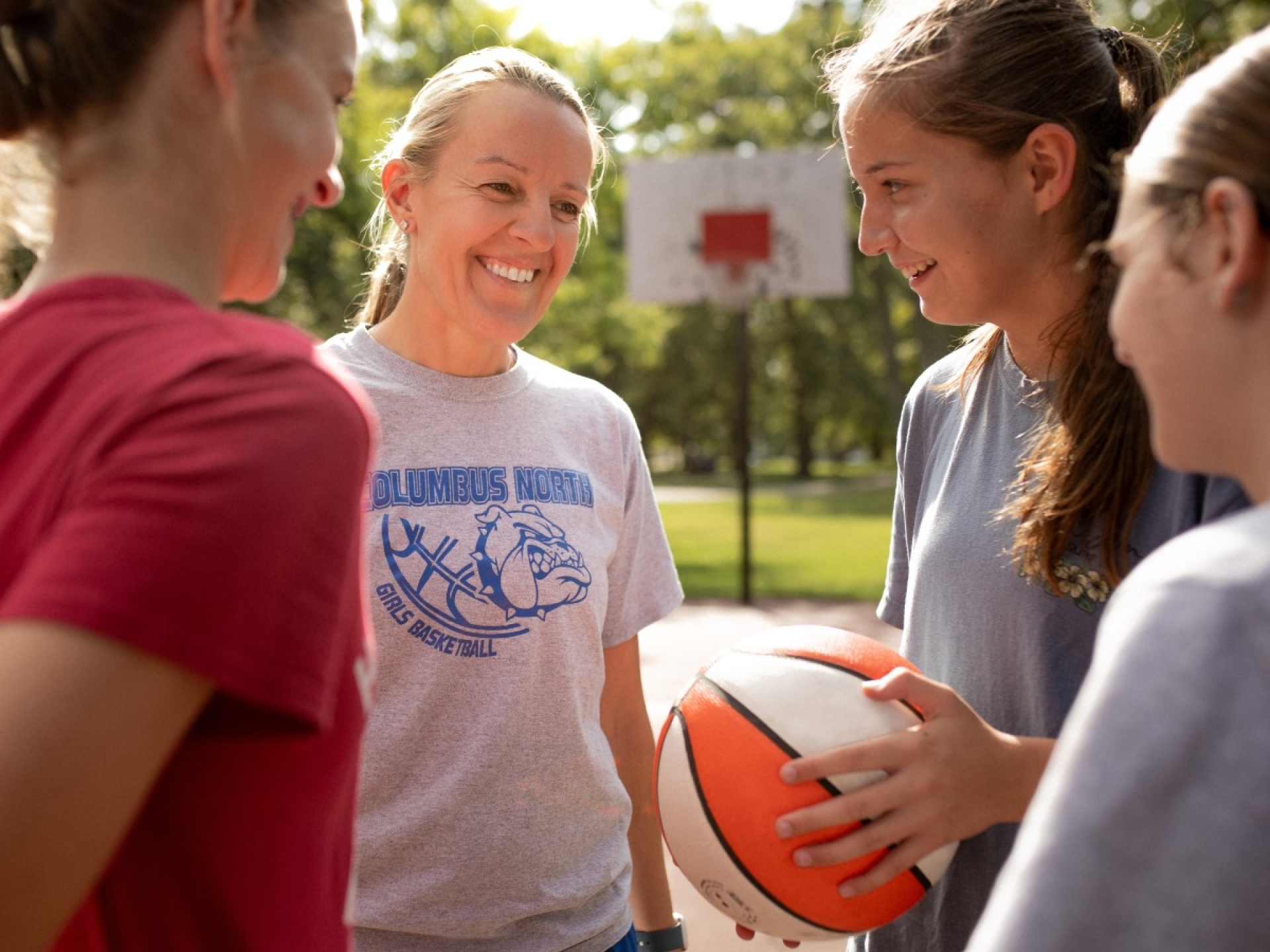 woman coaching youth basketball