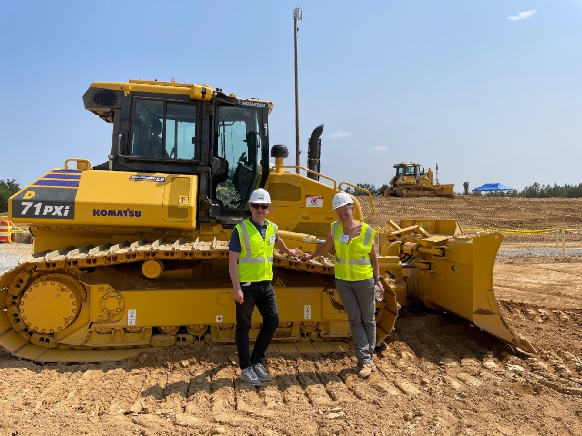 person standing next to bulldozer
