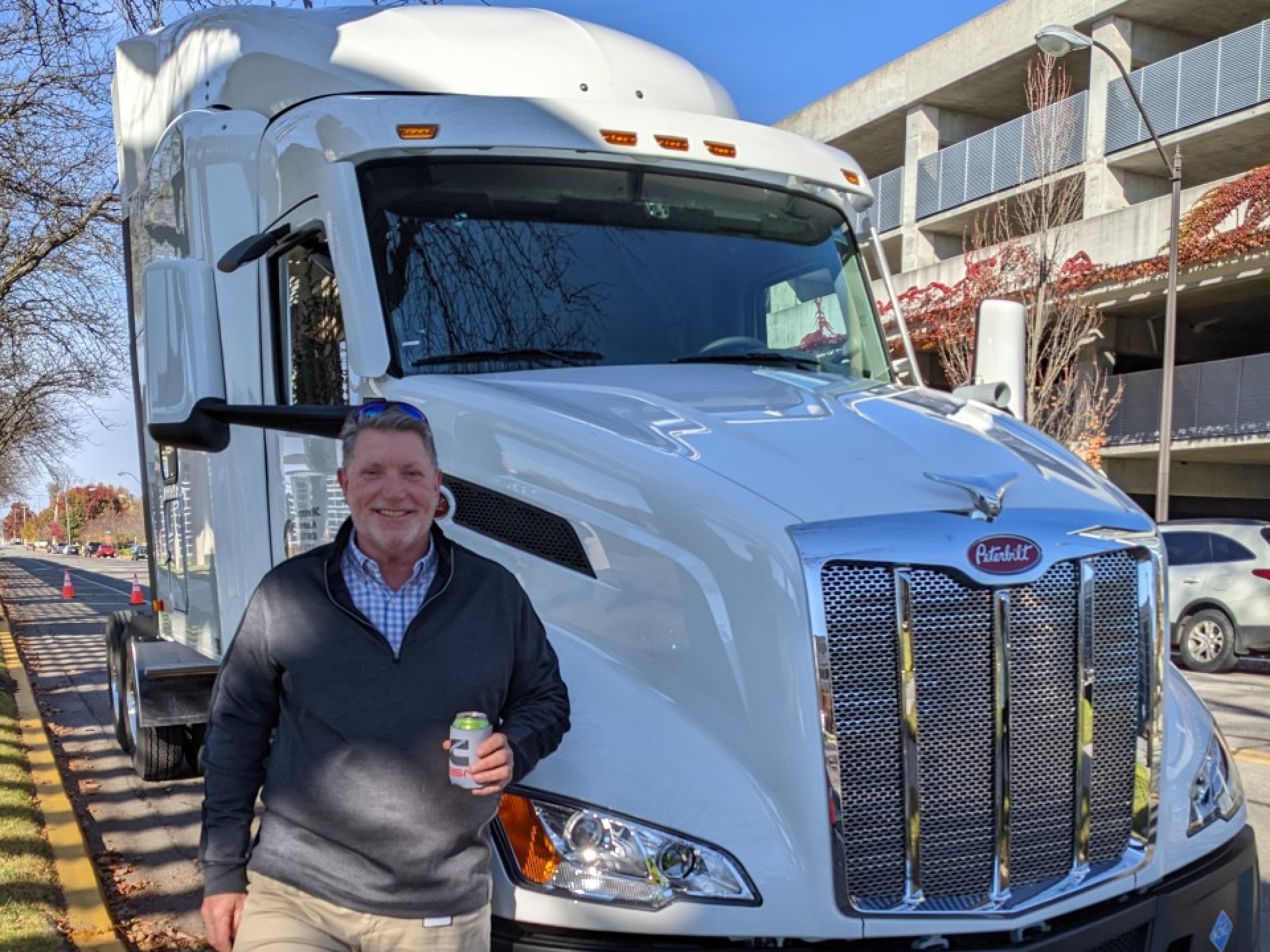 Man taking a photo in front of a truck