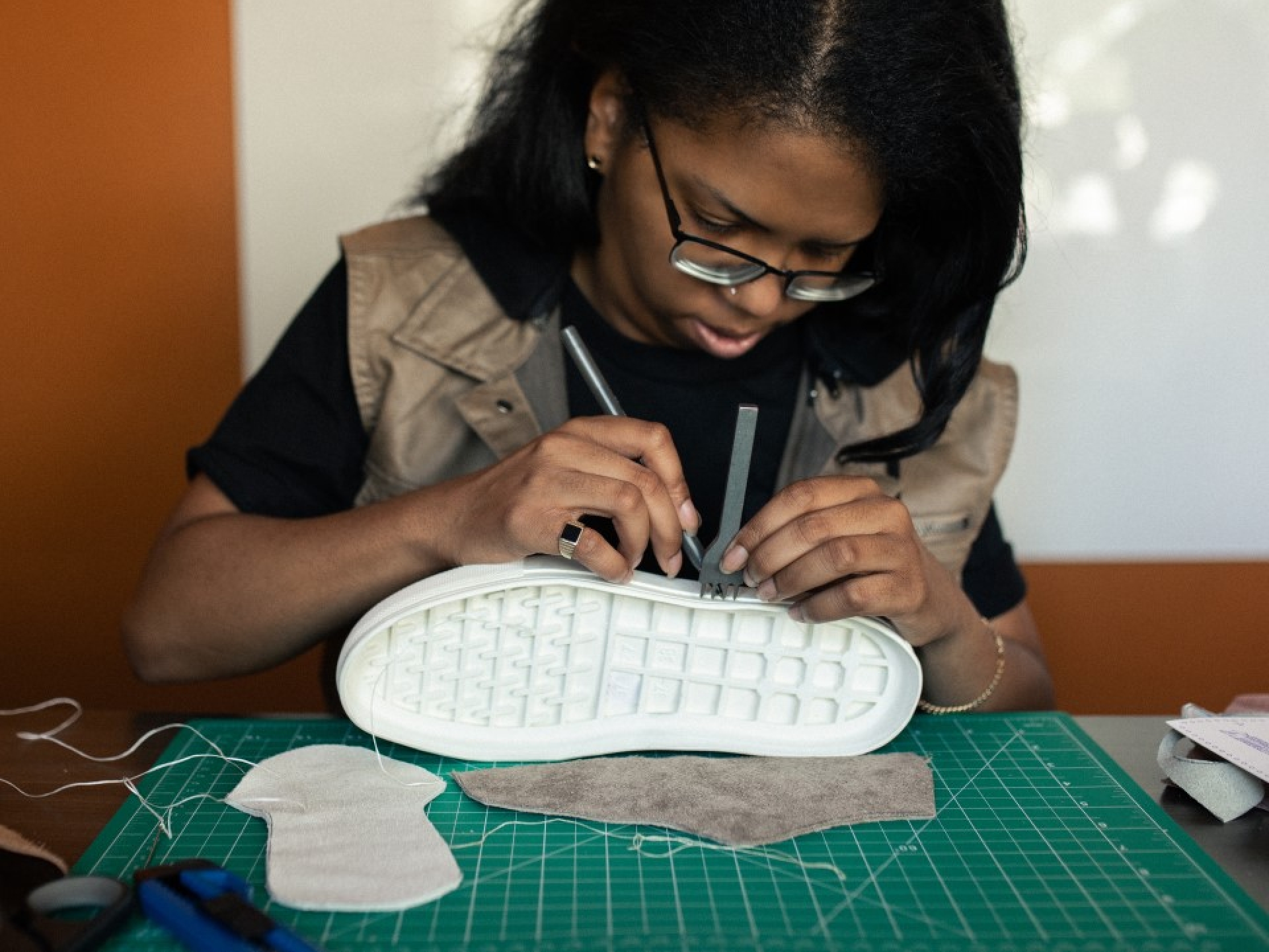 Shavonn working on a sole of a sneaker