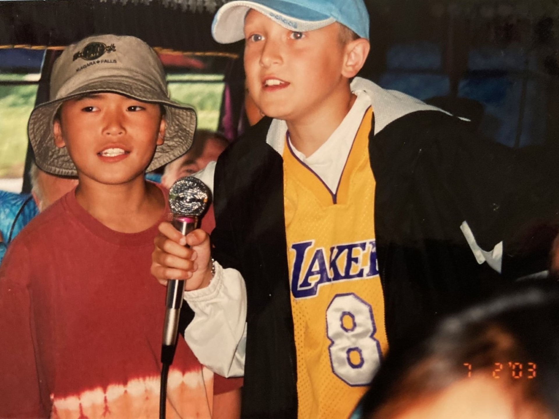 boys having fun with microphone in hand
