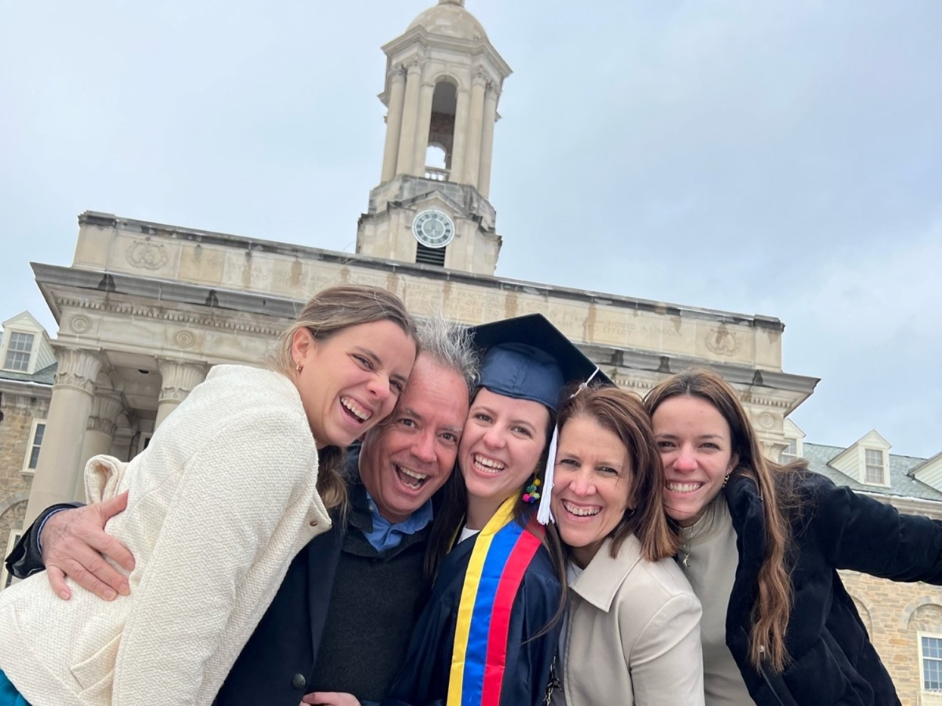 family in front of university building