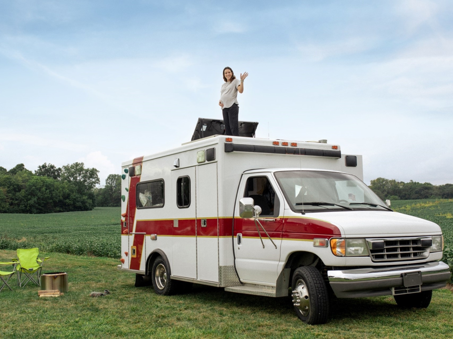 woman standing on top of camper van