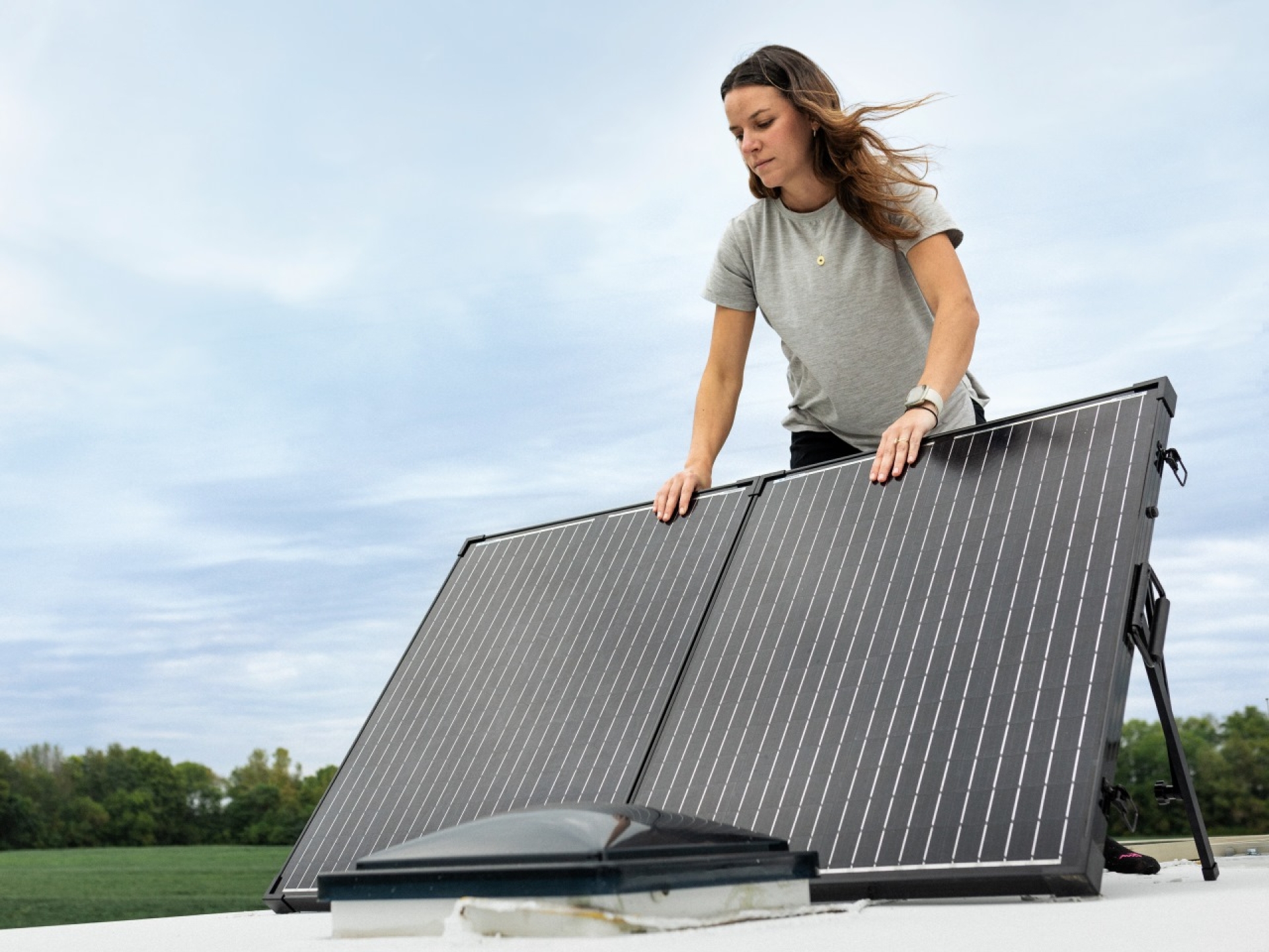 woman setting up solar panels