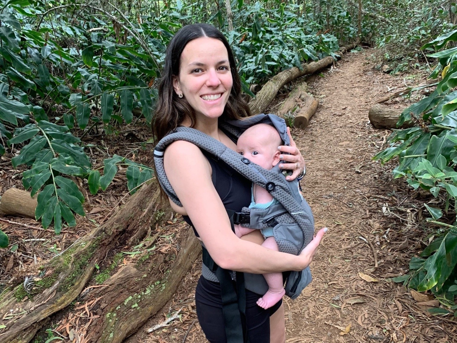 woman holding baby on hiking trail