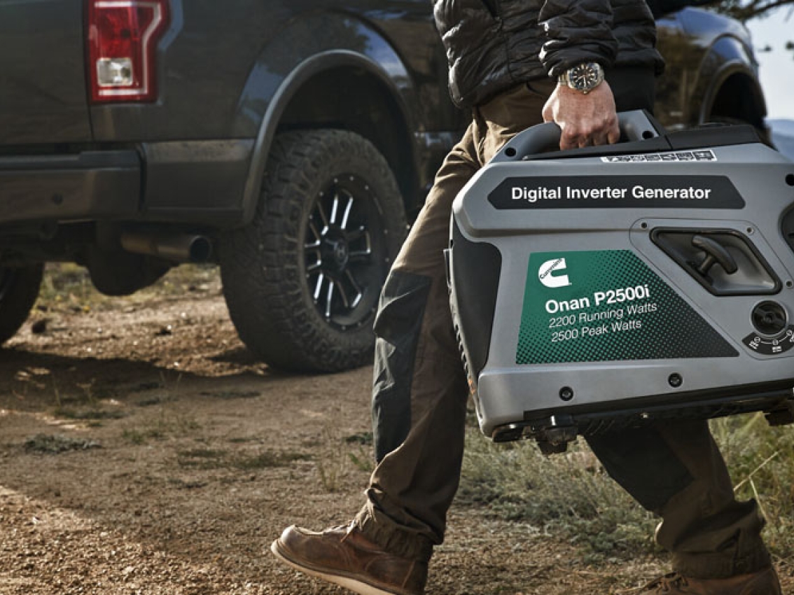 A person carries the cummins portable p2500i generator A person carries the cummins portable p2500i generator