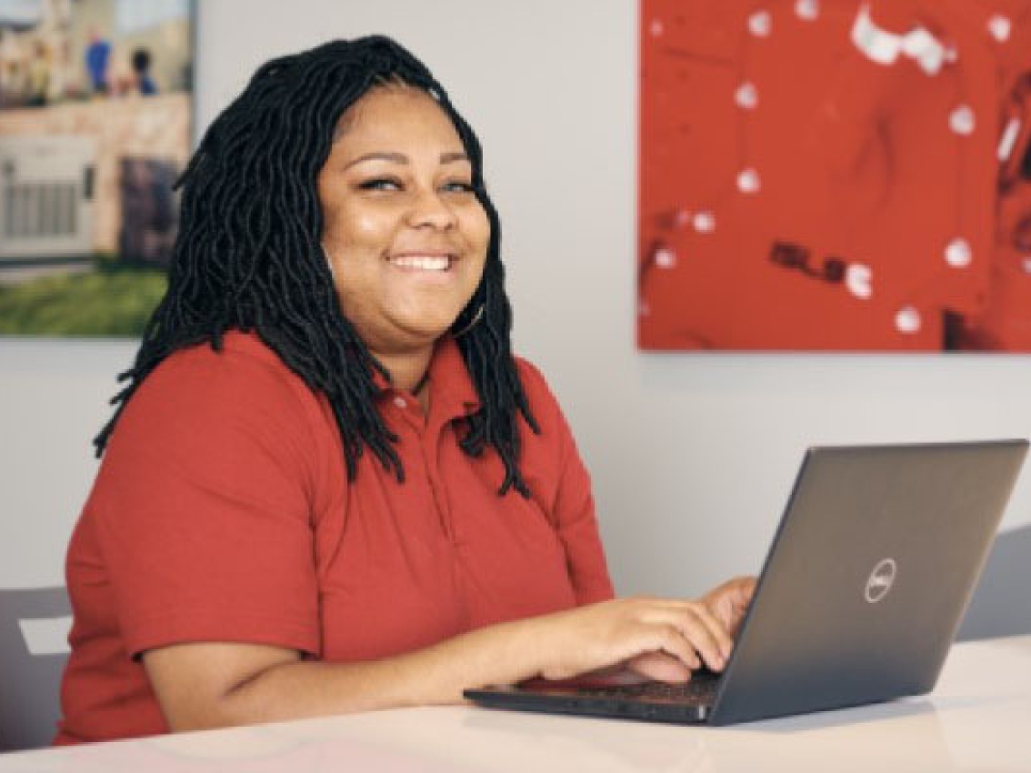 cummins employee sitting at desk using a laptop