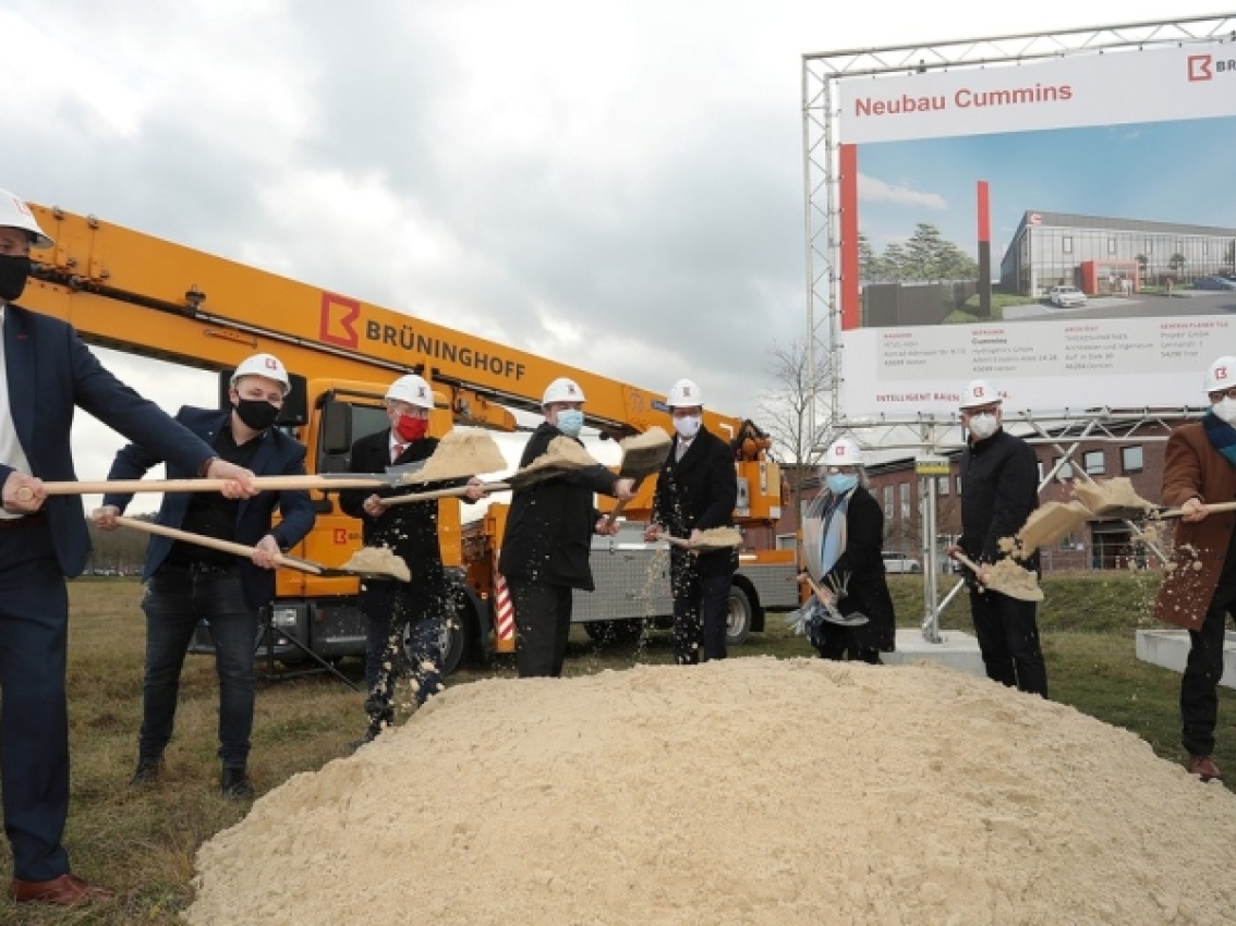 employees digging at groundbreaking ceremony