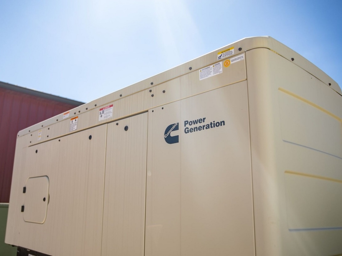 Sun shinning on a Cummins home generator