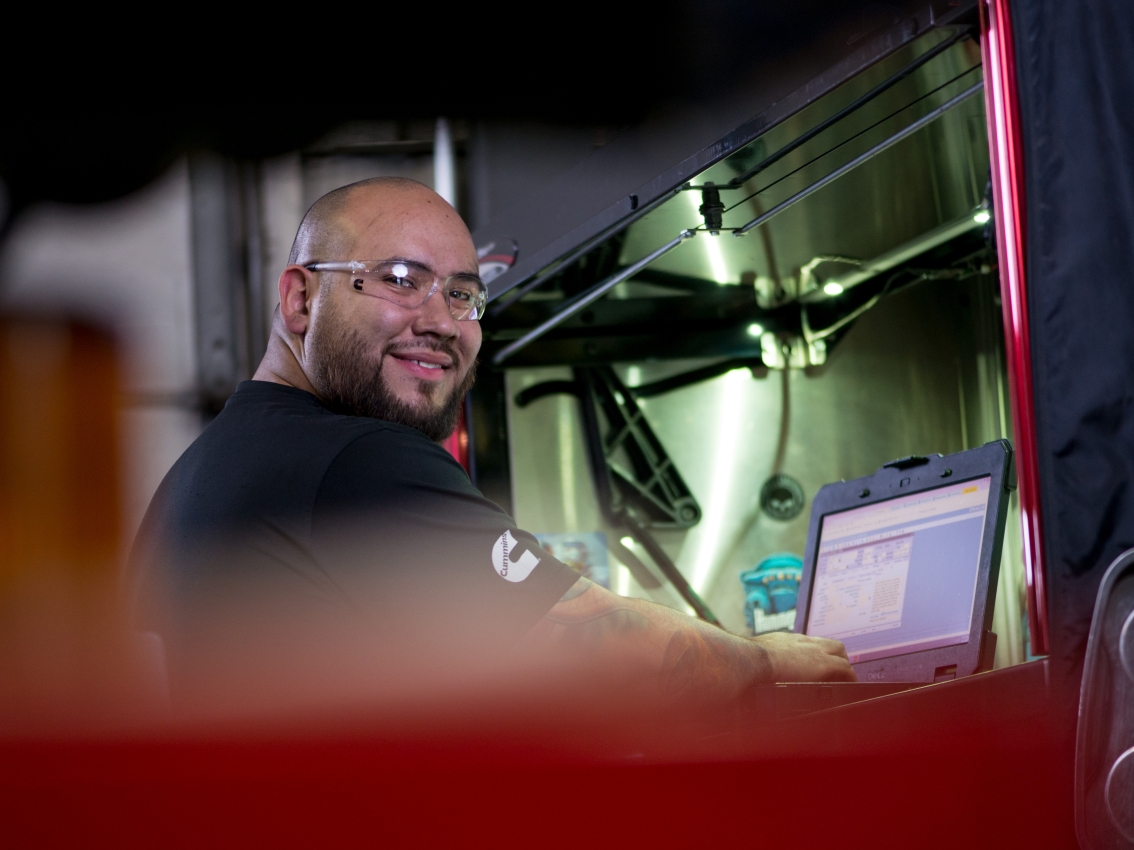Customer Support technician working at laptop