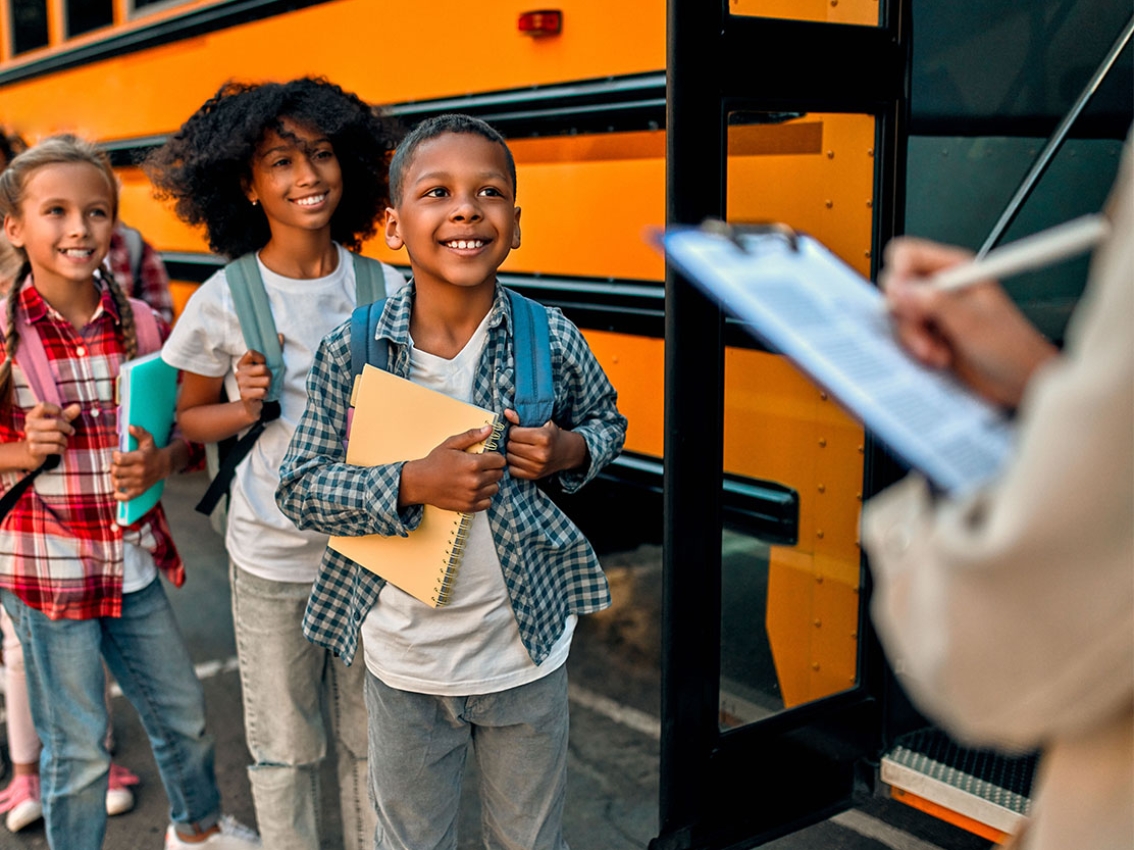 Kids being greeted at a school bus