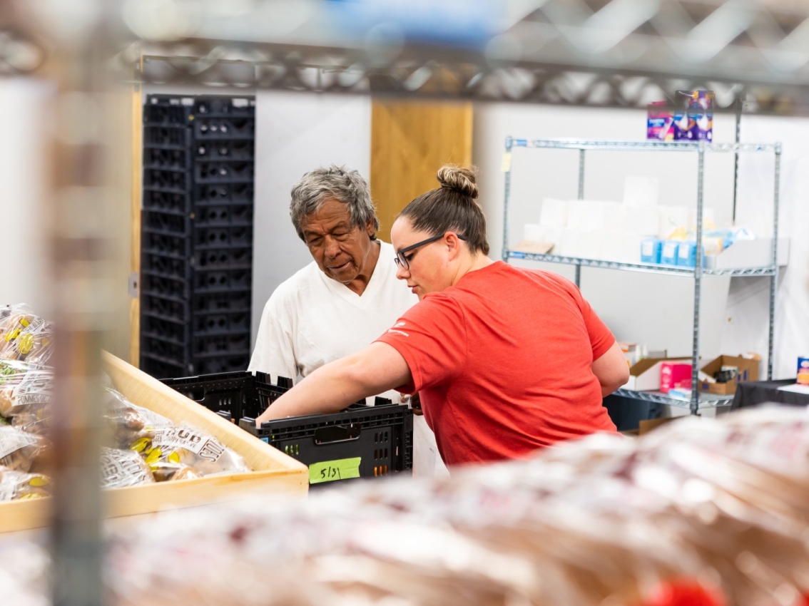 woman helping man during volunteer event