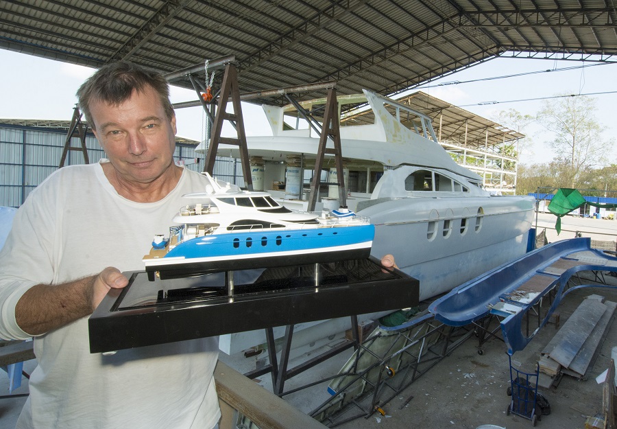 2.	James Dewing with a model of his catamaran that he has exhibited at shows around the globe. 