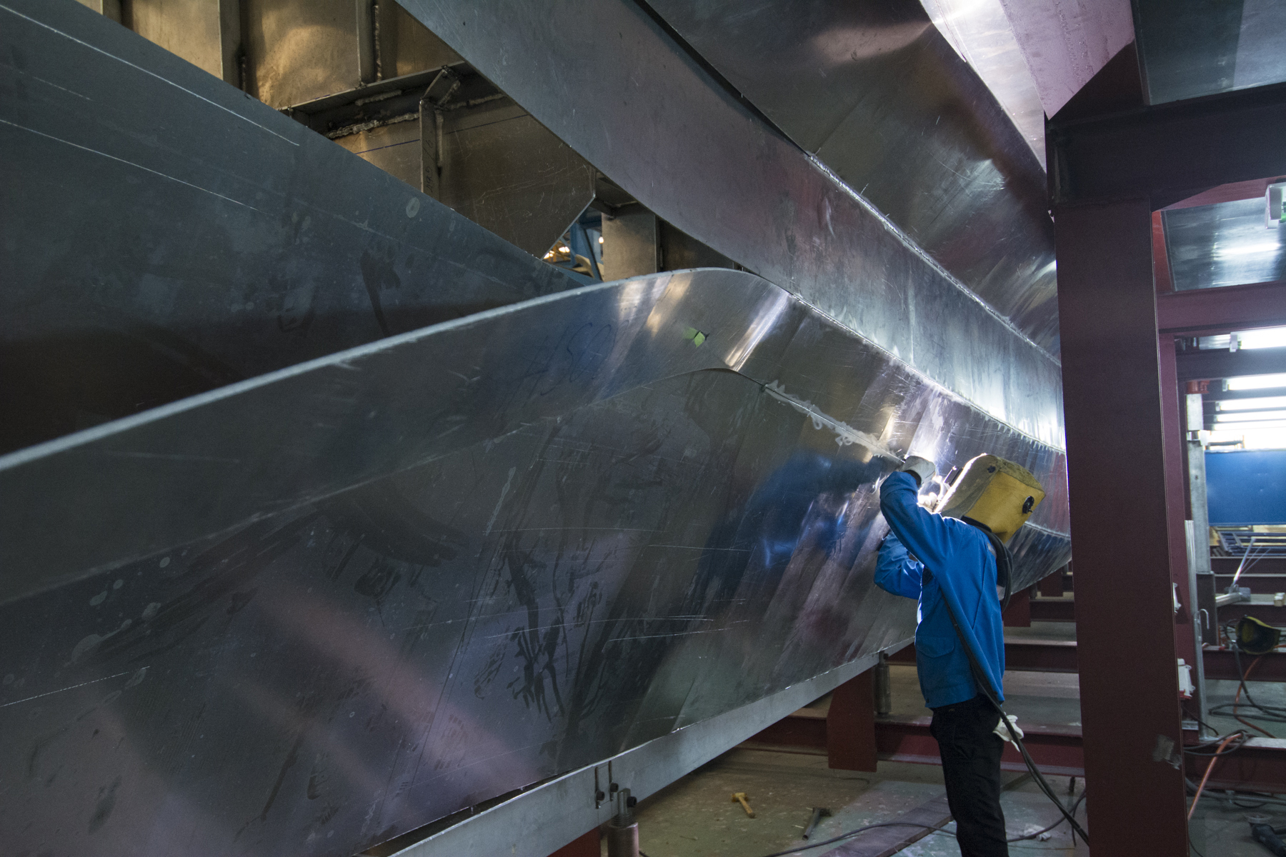 Welding the pressed hull panels together for a new catamaran at the ship in Suphanburi, Thailand.