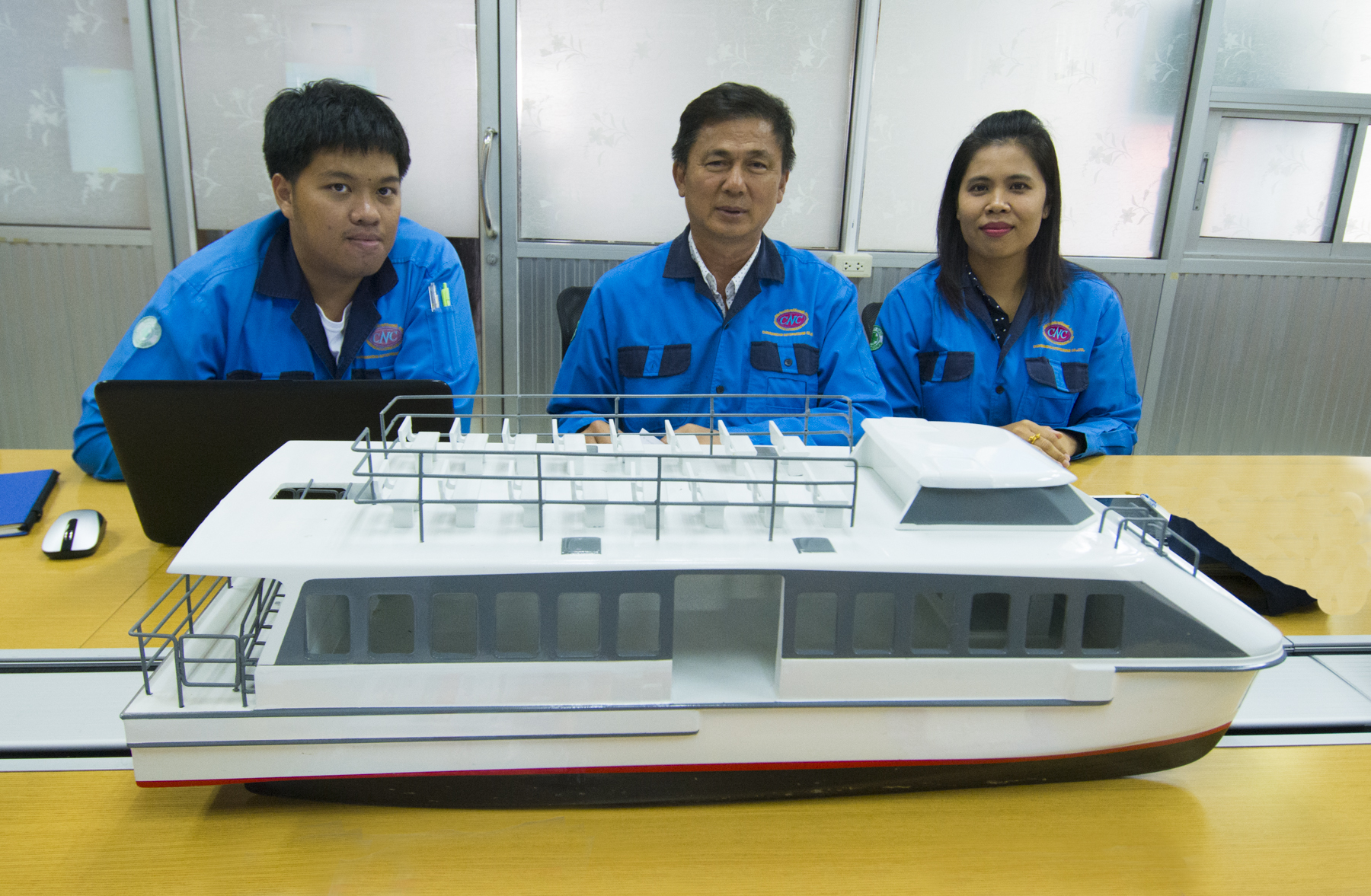 Left to right, R&D Patdanai Satapattayanont, Managing Director Namchai Sakunchoknamchai, Secretary Doungporn Pimsin with catamaran model