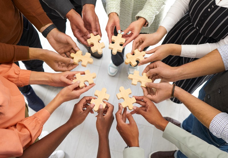 People holding puzzle pieces