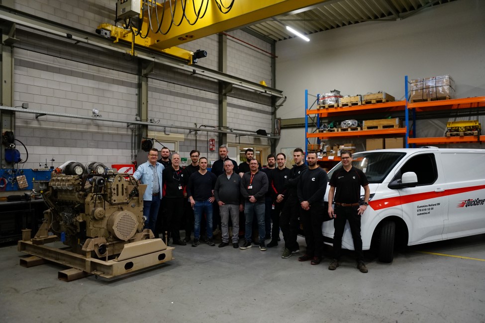 technican team in warehouse posing for group photo
