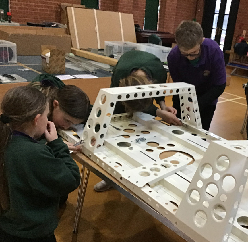 Students at West Park Academy working on the car