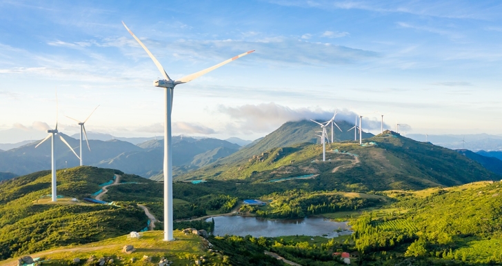 A windfarm across a mountainous landscape