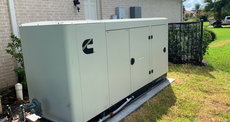 Tan home generator with Cummins logo