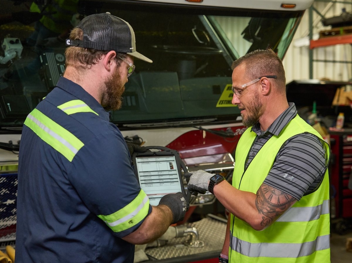 technicians looking over inspection report